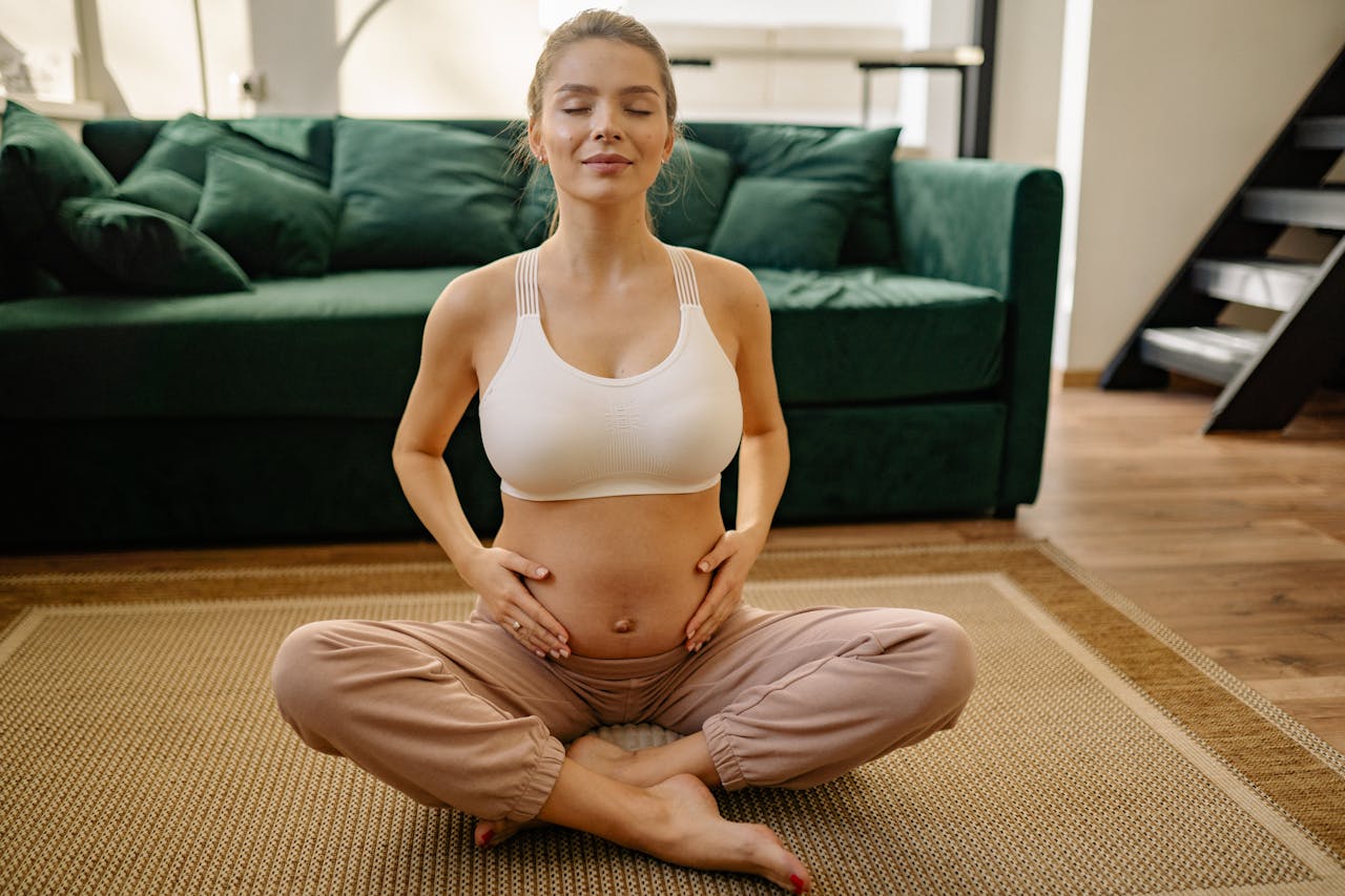 A pregnant woman stretching to prepare her body for birth.